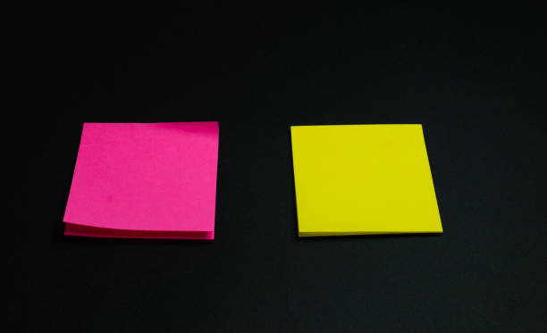 istock empty square multi-colored stickers hang on a black board, business concept 1190465665