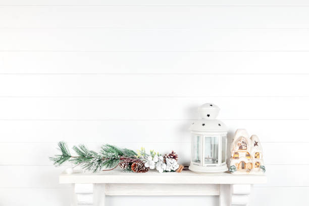 istock white wall in a room with spruce branches, cones and a lantern 1190465770