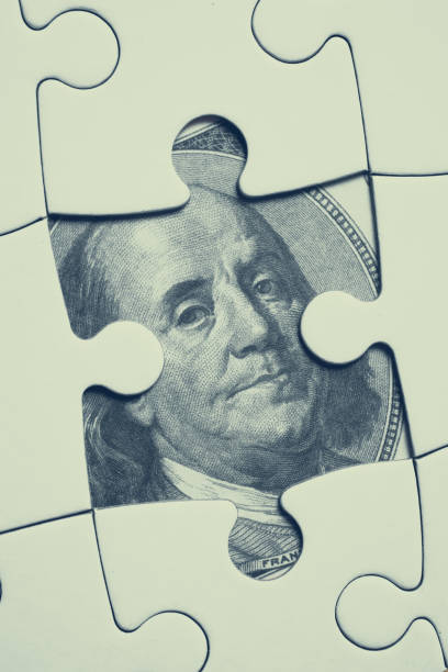 istock Image on 100 U.S. dollar bill image opened under the white jigsaw puzzle. 1190466152