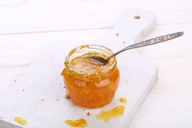 istock Tangerine jam on white wooden background 1190467149