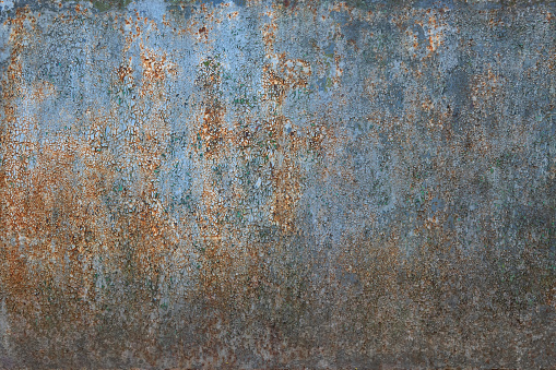 Old metal sheet with cracked blue paint. There is rust. Background. Texture.