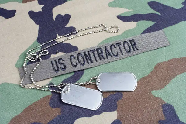 US CONTRACTOR branch tape and dog tags on woodland camouflage uniform