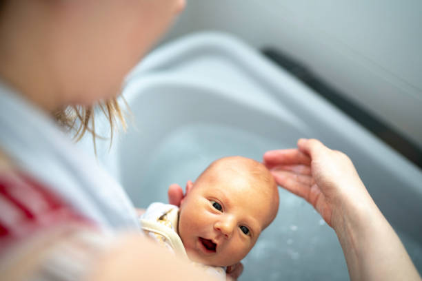 istock Mother giving a bath to her newborn 1190475554