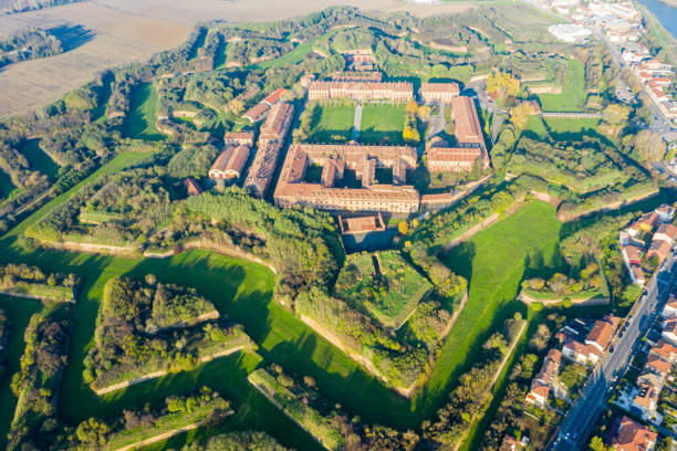 Aerial helicopter view of walls, moats, bastions, earthworks, outworks and barracks of modern six-star hexagon shaped renaissance fortress Cittadella of Alessandria on river Tanaro. Piedmont, Italy stock photo