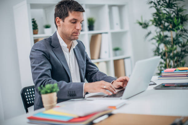 istock Young businessman using laptop at the office 1190476562