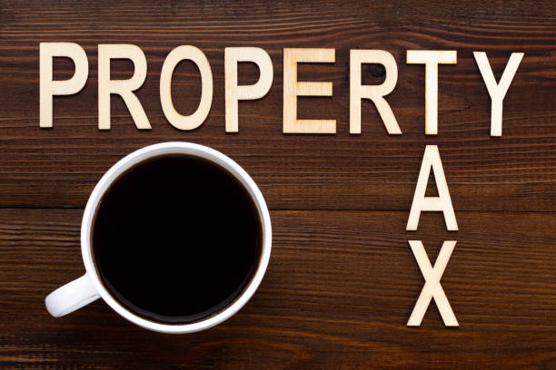 Property Tax Wooden Blocks With a cup of coffee On Wooden Table stock photo