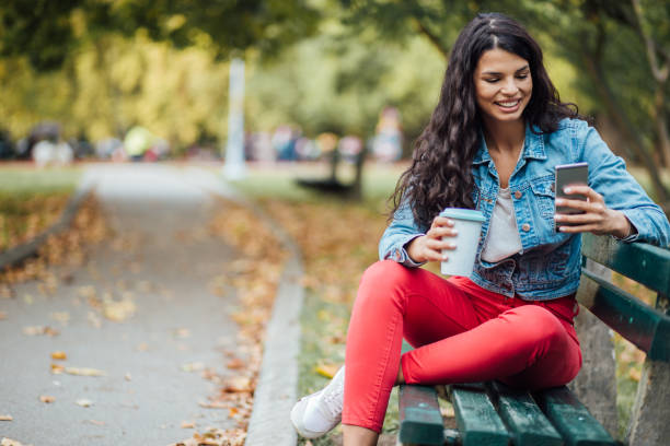 istock Young woman sitting on the bench 1190483848