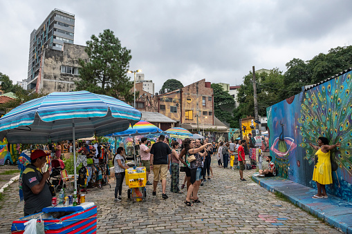 São Paulo, Brazil - April 13, 2019: Street life in Beco do Batman (Batman Alley) in Vila Madalena, a trendy area of São Paulo known for its street art.