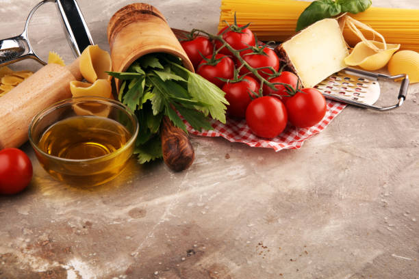 istock Pasta, vegetables, herbs and spices for Italian food on rustic table 1190491658