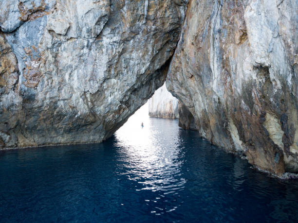 istock Man paddling under stone arch 1190491752
