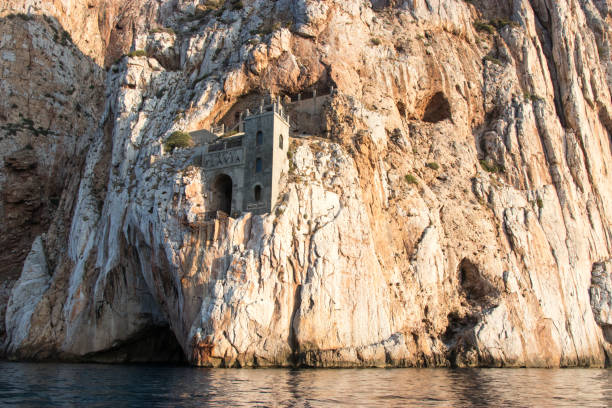 istock Stone building in rocky cliff above the sea 1190492043