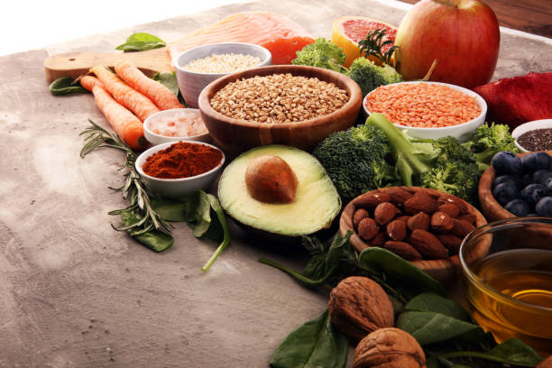 istock Healthy food clean eating selection: fish, fruit, vegetable, cereal, leaf vegetable on rustic background 1190495813