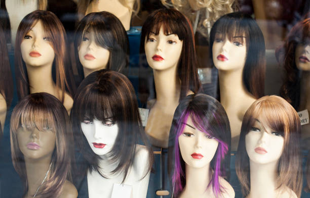 istock Mannequin heads with wigs in store window. 1190495892