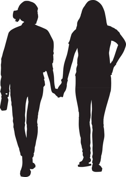 Two Young Women Walking Holding Hands Vector silhouette of two young women walking together holding hands. gay long hair stock illustrations