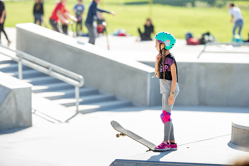Skater Girl Preparing to Drop In on Ramp - Stock Photo