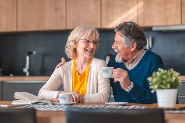 istock Cheerful senior couple talking at dining table 1190505328