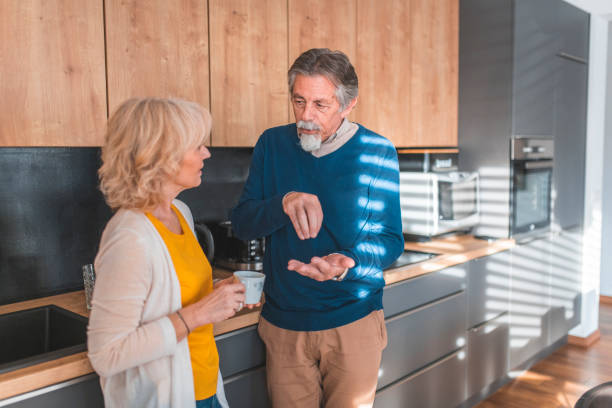 istock Senior man gesturing while talking with woman 1190505362