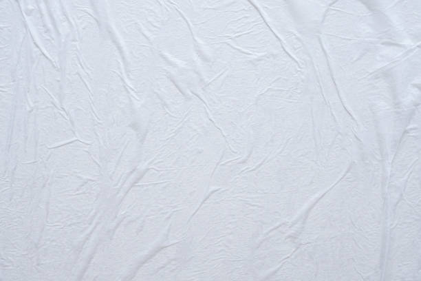 istock Blank white crumpled and creased paper poster texture background 1190505703