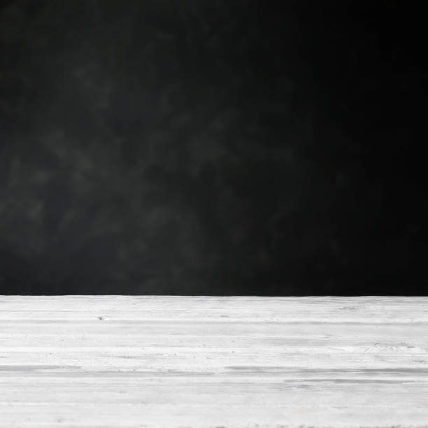 istock background with white wooden table and dark wall 1190505785