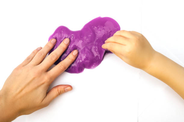 istock Violet slime with hands, isolated on white. 1190506559