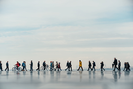 People of walking with reflection on a rainy day