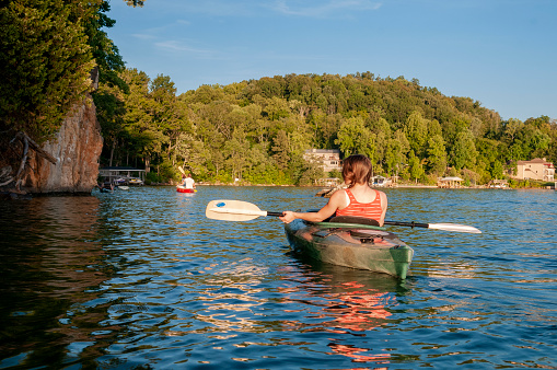 Young adults paddle a kayak and canoe on Boone Lake near Johnson City, Tennessee