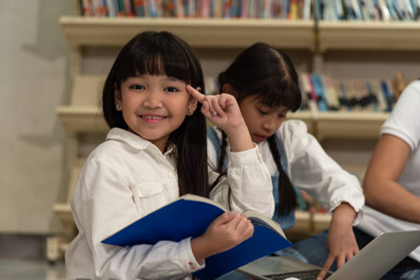istock Education image,asian children happy learning in library at school. 1190515937