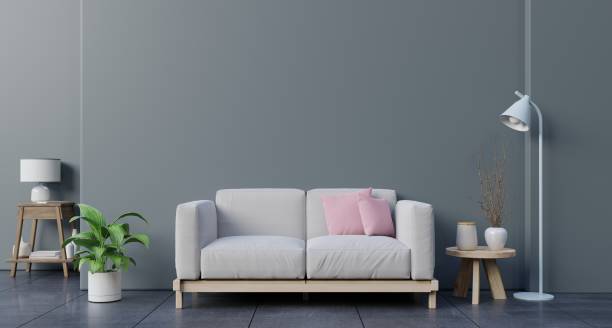 istock Mock up wall in living room with sofa, plants and table on empty dark wall background. 1190520589