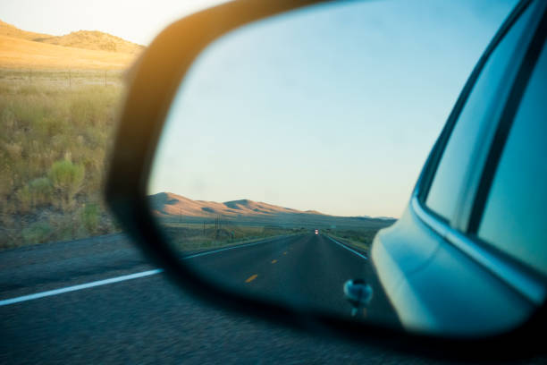 istock Rear Mirror of a Car on Highway During Sunset 1190527299