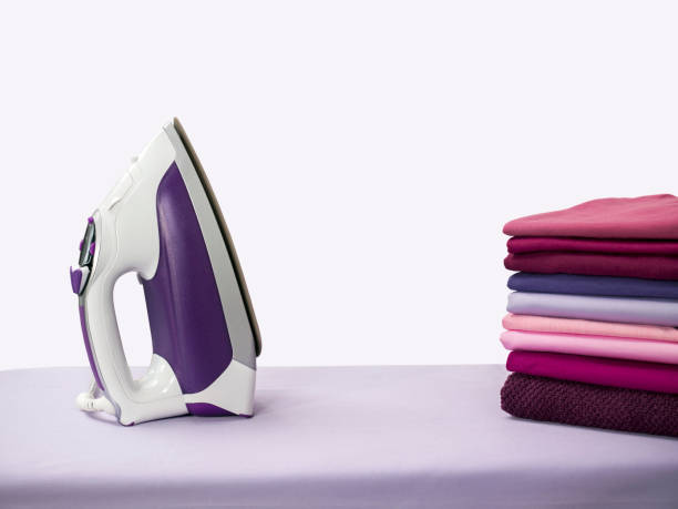 Iron and folded shirts Iron and folded shirts iron appliance photos stock pictures, royalty-free photos & images