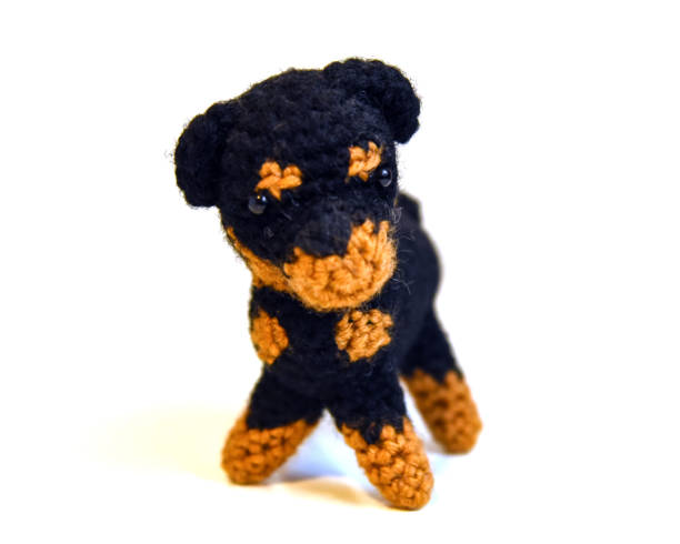 istock Crocheted miniature Rottweiler toy on white background 1190532656