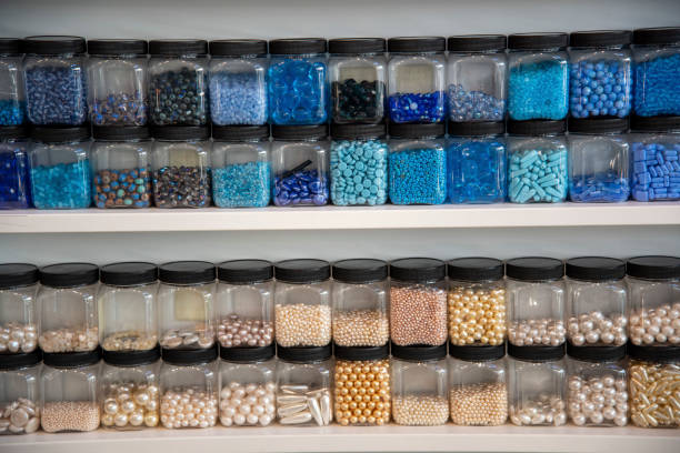 istock Bottles and rows of coloured beads used in craft work. 1190541717