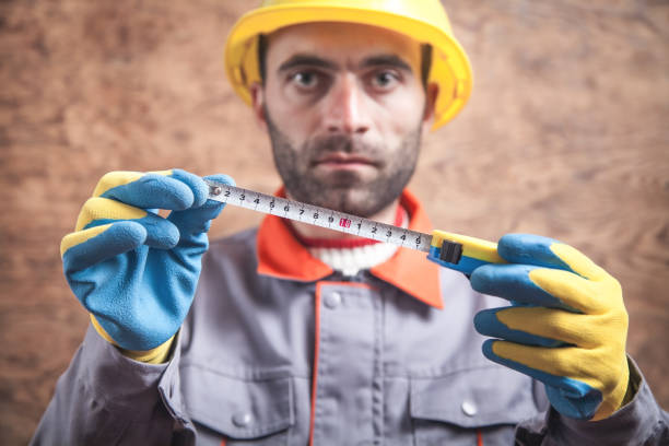 istock Caucasian worker holding a tape measure. 1190547714