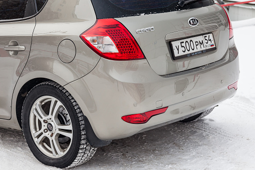 Novosibirsk, Russia - 08.01.2018: Beige Kia Ceed rear view on the car parking with snow background in the street.