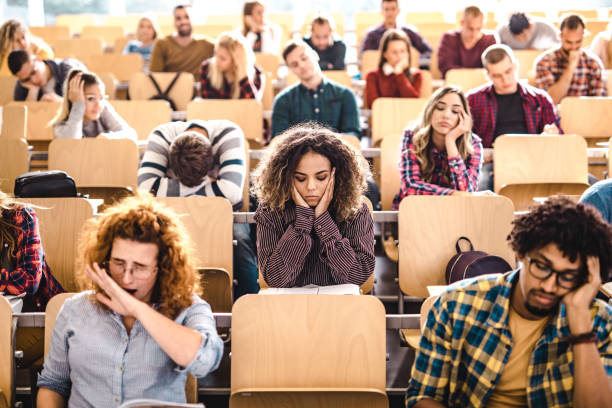 istock Large group of bored college students in a lecture hall. 1190548077