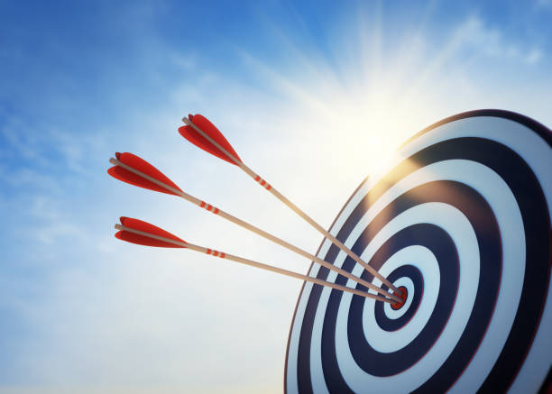 Archery target and arrow 3D on blue sky Archery target with hits by several arrows with sun and sky bulls eye photos stock pictures, royalty-free photos & images