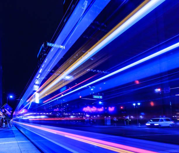 istock Brightly colored lights shine against an urban setting at night 1190553113