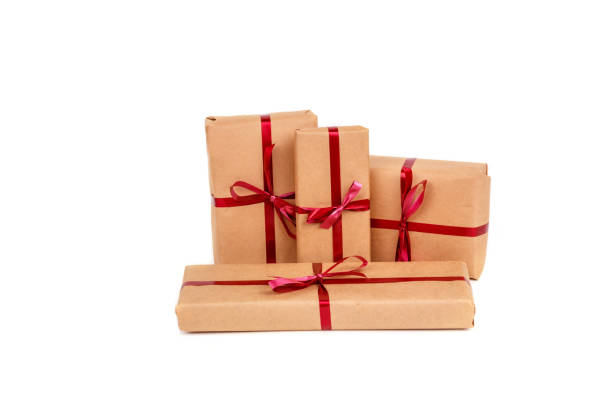 istock Gift Boxes in Craft Wrapping Paper with Red Ribbons isolated 1190553394