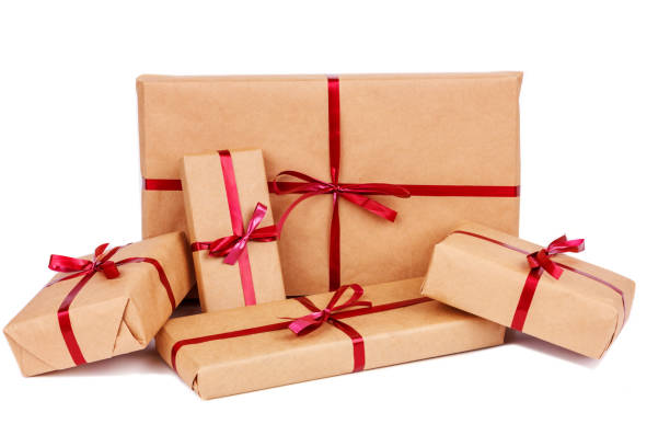 istock Gift Boxes in Craft Wrapping Paper with Red Ribbons isolated 1190553402