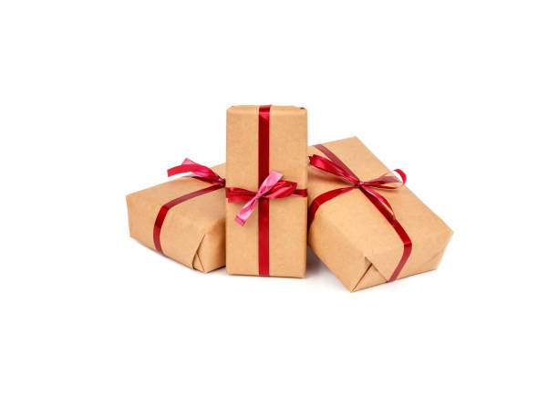 istock Gift Boxes in Craft Wrapping Paper with Red Ribbons isolated 1190553404
