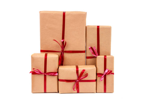 istock Gift Boxes in Craft Wrapping Paper with Red Ribbons isolated 1190553960
