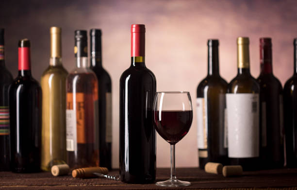istock Red Wine in glass and bottles on a dark background with copy space 1190554475