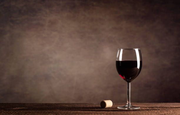 istock Red Wine in glass on a dark background with copy space 1190554481