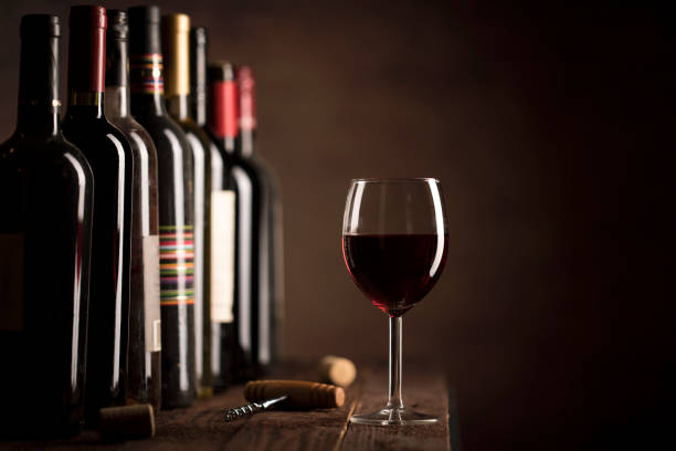Red Wine in glass and bottles on a dark background with copy space stock photo