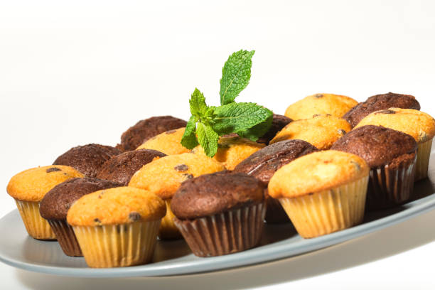 istock Assorted fresh delicious muffins isolated on white background 1190554751