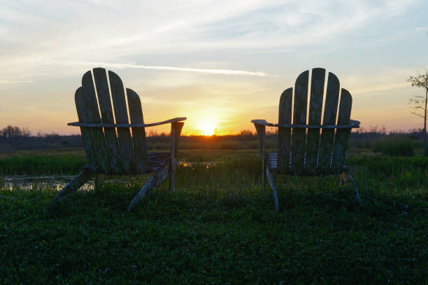istock Louisiana sunset swamp and chairs 1190557111