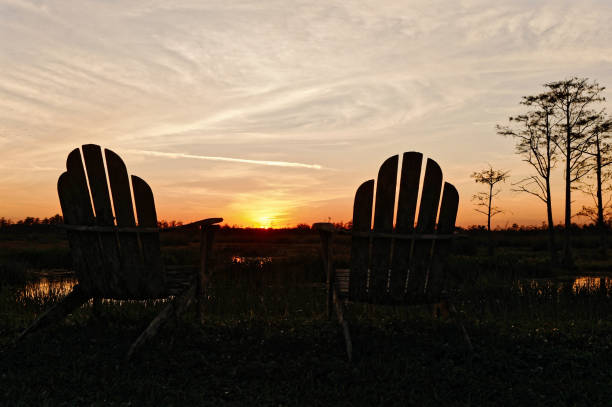 istock Louisiana sunset swamp and chairs 1190557128