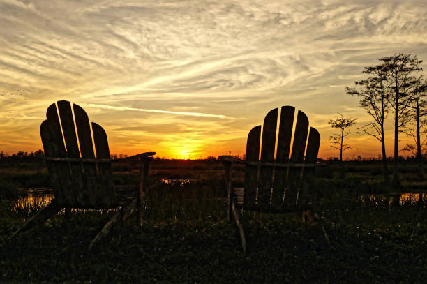 istock Louisiana sunset swamp and chairs 1190558065