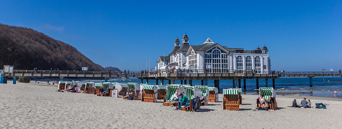 Panorama of beach chairs in front of the sea bridge in Sellin on Rugen island, Germany