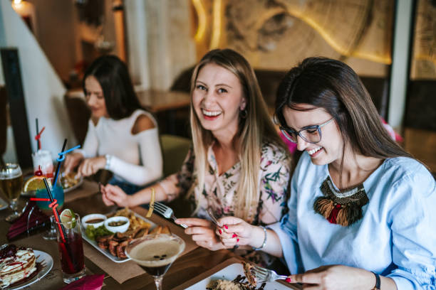 istock Female friends eating at restaurant 1190560192